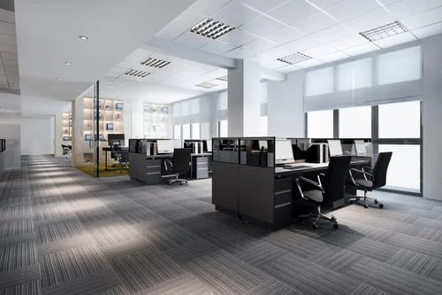 Wide carpeted walkway and shared workspace kept clean inside a modern New Jersey building