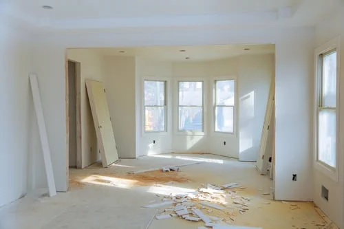 Sunlit new-build room with drywall debris and dust before final cleanup by a New Jersey post-construction cleaning crew.